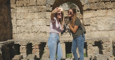 Tourists take photos near ancient temple roman architecture in open air museum