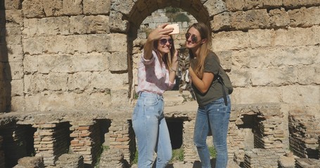 Tourists take photos near ancient temple roman architecture in open air museum