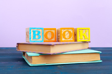 cube wooden block with alphabet building the word book
