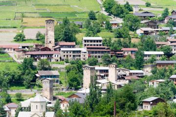 Obraz premium Mestia, Georgia - Jun 22 2018: Ancient towers with Mountain village. a famous landscape in Mestia, Samegrelo-Zemo Svaneti, Georgia.