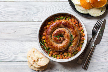 Italian sausage - salsiccia fresca, with bean stew and rosemary on a white background