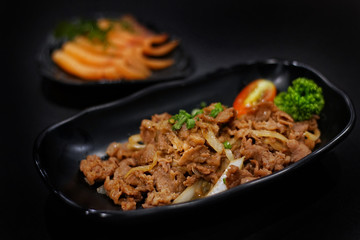 Japanese food: Stirred beef with sauce served with Japanese cooked rice on table. Clean food concept. Toned image. Selective focus and free space for text.