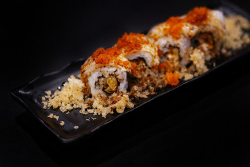 Japanese food: Maki roll with unagi served with Japanese cooked rice on table. Clean food concept. Toned image. Selective focus and free space for text.