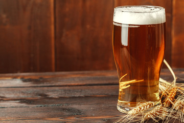 Glass beer on wood background