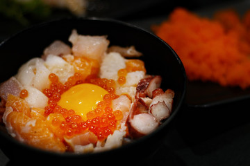 Japanese food: Mix sashimi and ebi served with Japanese cooked rice on table. Clean food concept. Toned image. Selective focus and free space for text.