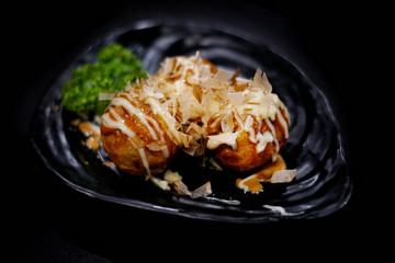 Japanese food: Takoyaki on table. Clean food concept. Toned image. Selective focus and free space for text.