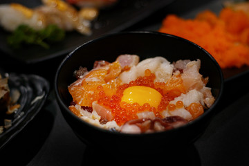 Japanese food: Mix sashimi and ebi served with Japanese cooked rice on table. Clean food concept. Toned image. Selective focus and free space for text.