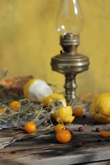 kerosene lamp, lemons and tomatoes, forks and knives