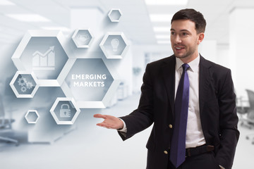The concept of business, technology, the Internet and the network. A young entrepreneur working on a virtual screen of the future and sees the inscription: Emerging markets