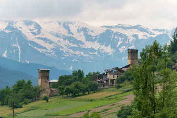 Mestia, Georgia - Jun 23 2018: Ancient towers with Caucasus Mountains in Mestia, Samegrelo-Zemo Svaneti, Georgia.