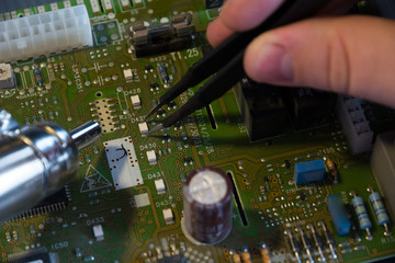 Male hands close up checking voltage on a microchip