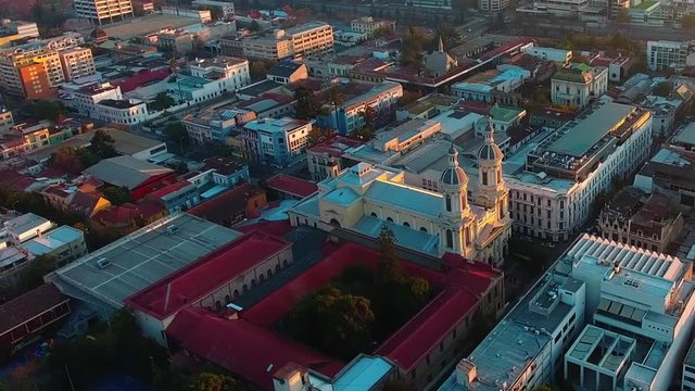Tourist catholic Iglesia San Ignacio
design church amidst urban city of Santiago, drone shot