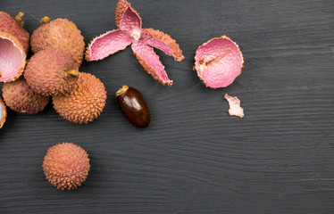 Lychee fruit on black wooden background