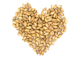 Pistachios in the form of hearts. A handful of pistachios on a white background