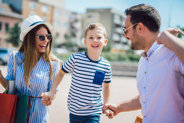 Obraz premium Happy family having fun outdoor after shopping