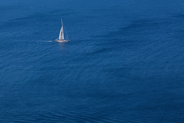 Fototapeta premium White yacht on blue sea background