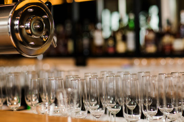 Empty glasses set with tissues and red rose in the restaurant