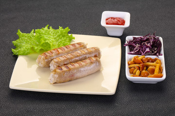 Grilled sausages served mushrooms and cabbage
