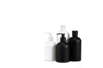 Black and white cosmetic bottles isolated on white