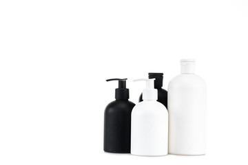Black and white cosmetic bottles isolated on white