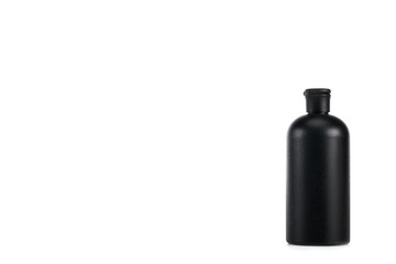 Black cosmetic bottle with cap isolated on white