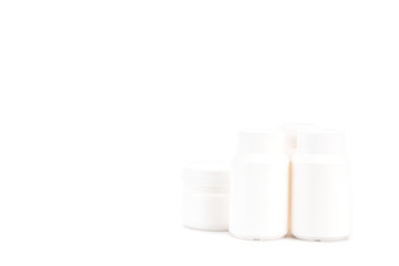 White cosmetic containers with caps isolated on white