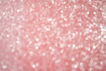 Blurred bokeh light red pink coral background, Christmas and New Year holidays background. Party concept. Festive holiday card bright backdrop. Defocused. Flat lay, top view, copy space.