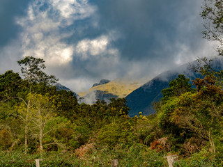 An overcasted landscape of the Andean moutains of central Colombia illuminated by the sunset light.