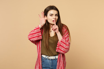 Young woman in casual clothes say hush be quiet with finger on lips shhh gesture, eavesdrop hearing...