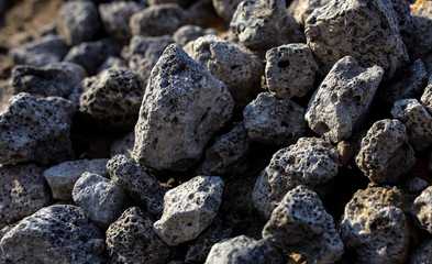 Stones on the edge of the asphalt road
