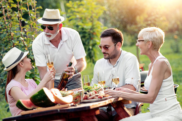 Family having lunch at summer garden party