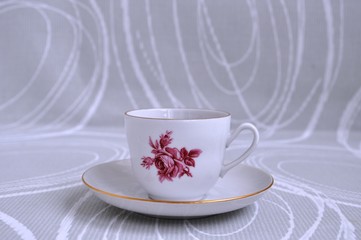 cup of tea with cookies, caramel, candy on an abstract gray background