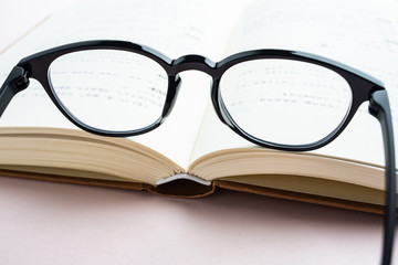 Glasses and book reading background material