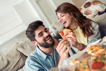 Lovely  couple eat pizza at home