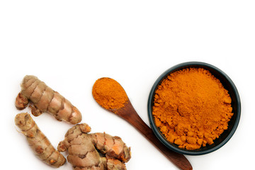 Organic healthy Turmeric powder in a bowl with Turmeric roots on white background