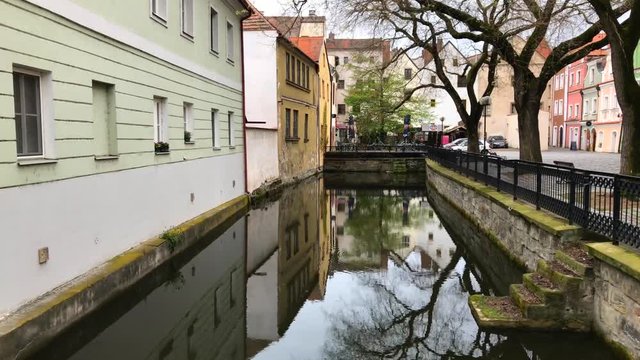 Old Europe. Pardubice. The river between the housesPalm trees and houses view. Old Europe. Pardubice. The river between the houses