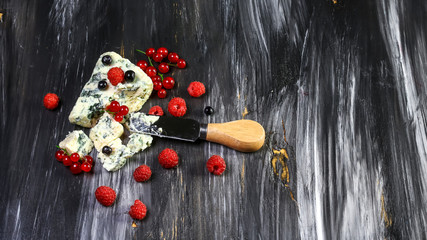 Danish blue cheese and raspberry on a wooden board. blue cheese with mild berries. top view