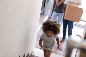 Happy African American family with daughter moving in new house