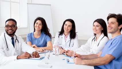 Fototapeta premium Young interns listening to professor in conference room