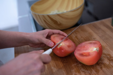 hands holding sharp knife and chopping