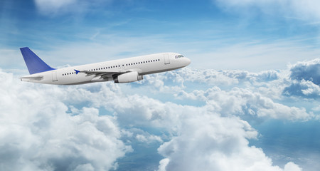 Fototapeta premium Commercial airplane jetliner flying above dramatic clouds.