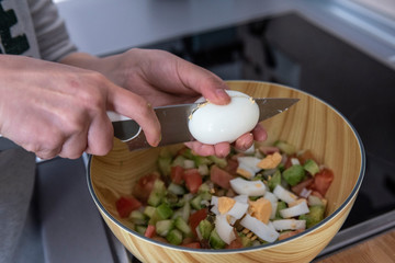 hands holding sharp knife and chopping