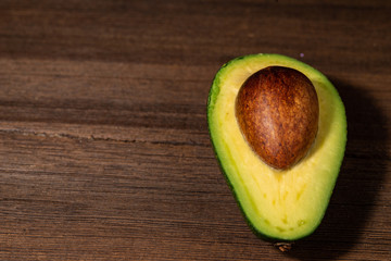 Fresh raw avocado on a cutting board. Top view with copy space.