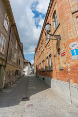 Fototapeta premium narrow street in the historic old city of Winterthur in Switzerland with traditional brick industrial houses