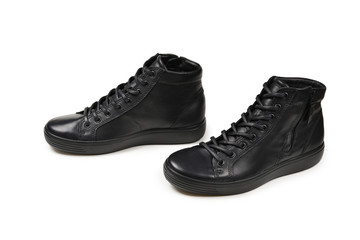 Men's black leather shoes and a black camera on a isolated on white background. Copy space.