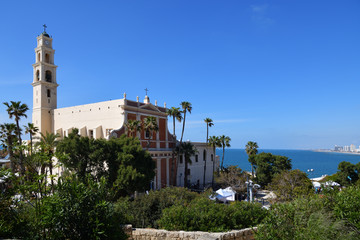 Fototapeta na wymiar St. Peter's Church. The bell tower with clock of the Church. Jaffa Israel