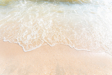 Sea beach with sand. Water wavey