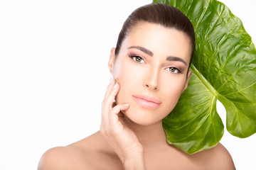 Skincare concept. Beauty spa woman and green leaf
