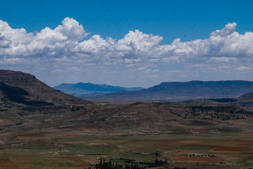 Open African landscape during day time with mountains and clouds