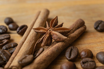 Spices with the coffee seeds on the wooden background
